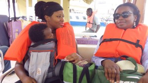 Leaving Sierra Leone with my son. Sitting next to me is former parliamentarian newly appointed Minister of State Isata Kabia. Ms. Kabia sponsored the right to abortion bill that was passed in parliament but that got sent back by the President after giving in to pressures from a male dominated assembly of religious leaders. Photo Credit: Go Woman Africa