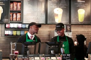 Baristas David Merrick (l.) and Nigel Armstrong (r.) predict the new Jamaica store will have a good effect on the community. Photo Credit: Michael Shain